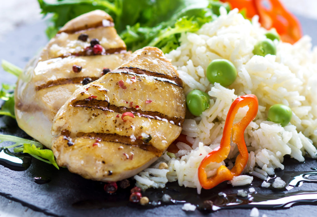 Delicious fried chicken breast and rice with chilli and salad