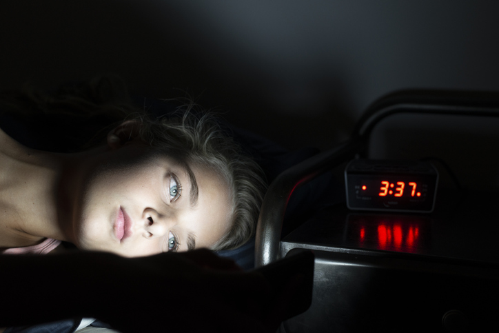 Girl using her smartphone late at night
